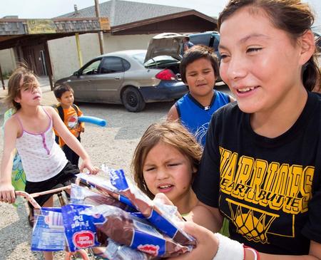 A girl purchases treats for her siblings outside of the Blackfeet Community Pool in Browning, Montana