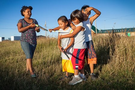 (Left to right) Mishayle Brumner (age 11),  Noah Burdeau (age 4) Keely Riehle (age 10),  and Gus Simon (age 9) play in an abandoned lot 