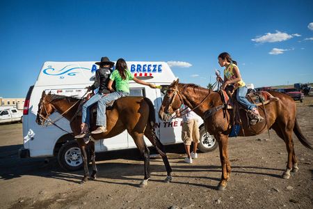 Youth rodeo particpants buy ice cream during a break.