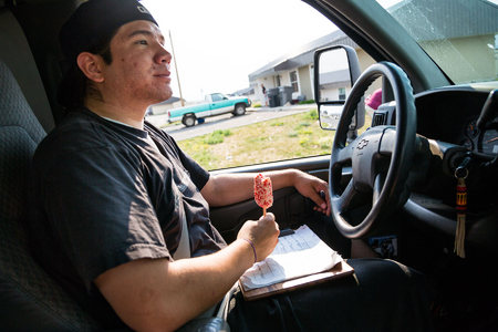 Ian Webber cruises his ice cream truck through the streets of Browning, in search of customers while blasting music from his ipod over the truck's speakers.