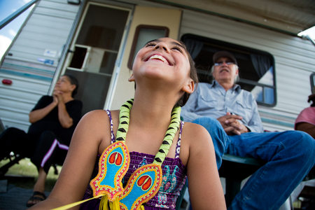 Shawnna Jeminez (age 7)  relaxes with her family after the jingle dance competition at the Heart Butte Pow Wow.
Blackfeet Indian Reservation, Montana