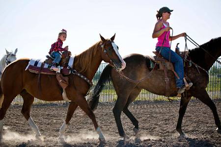 Jayme Bird leads her 3-year old daughter, Bailey around the arena.