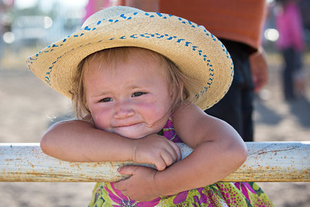 Dally Michael (2) watches her siblings compete in the summer Youth Rodeo.